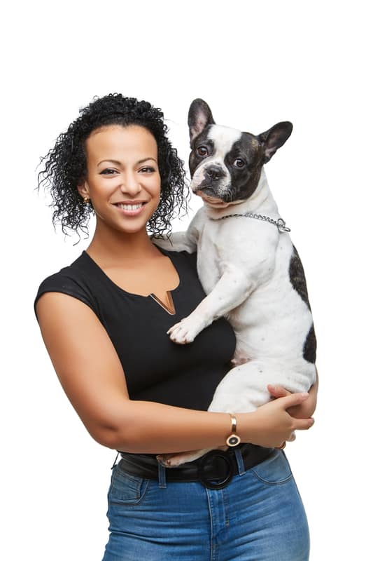 beautiful young woman holding french bulldog dog. studio shot isolated on white background. copy space.